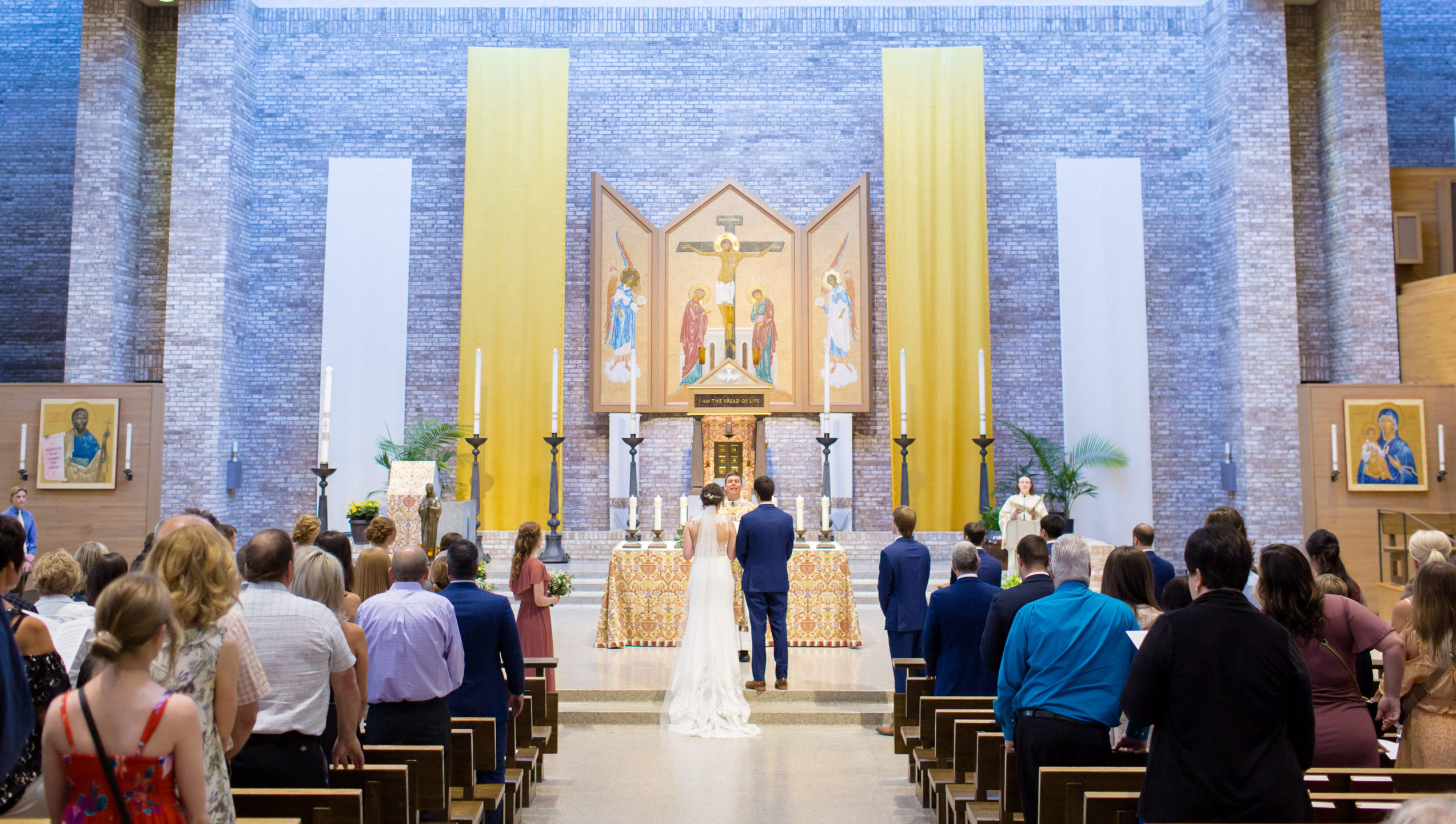 Couple at altar exchanging vows at Catholic Church