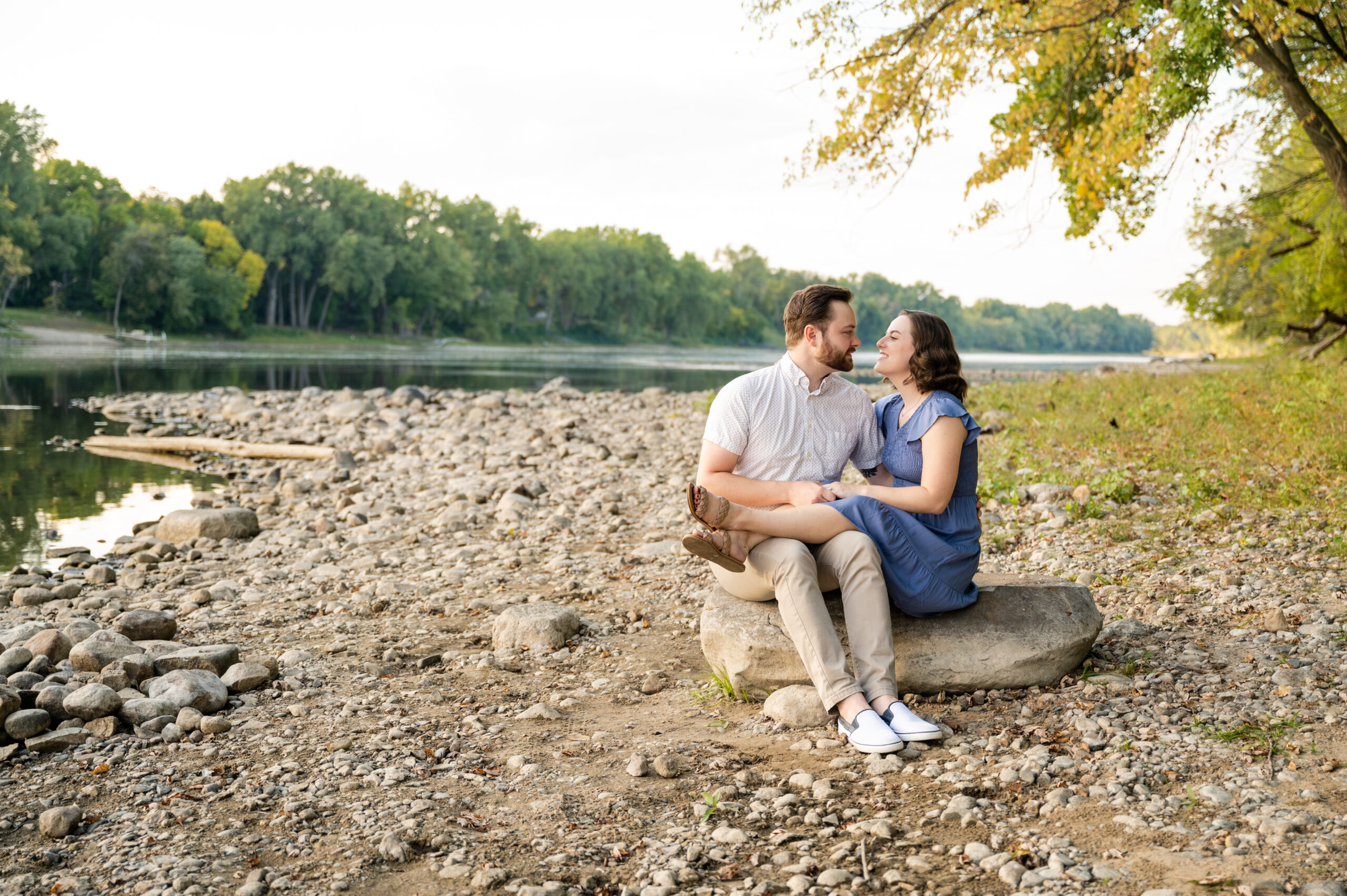 Couple sitting next to each other on rock at the bank of the Mississippi River