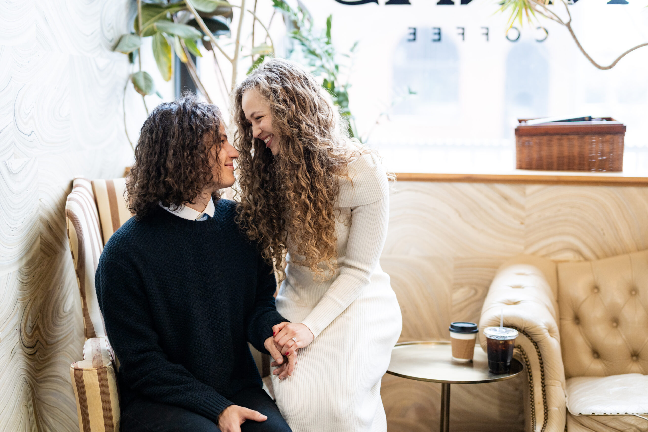 Engaged couple at coffee shop looking at each other