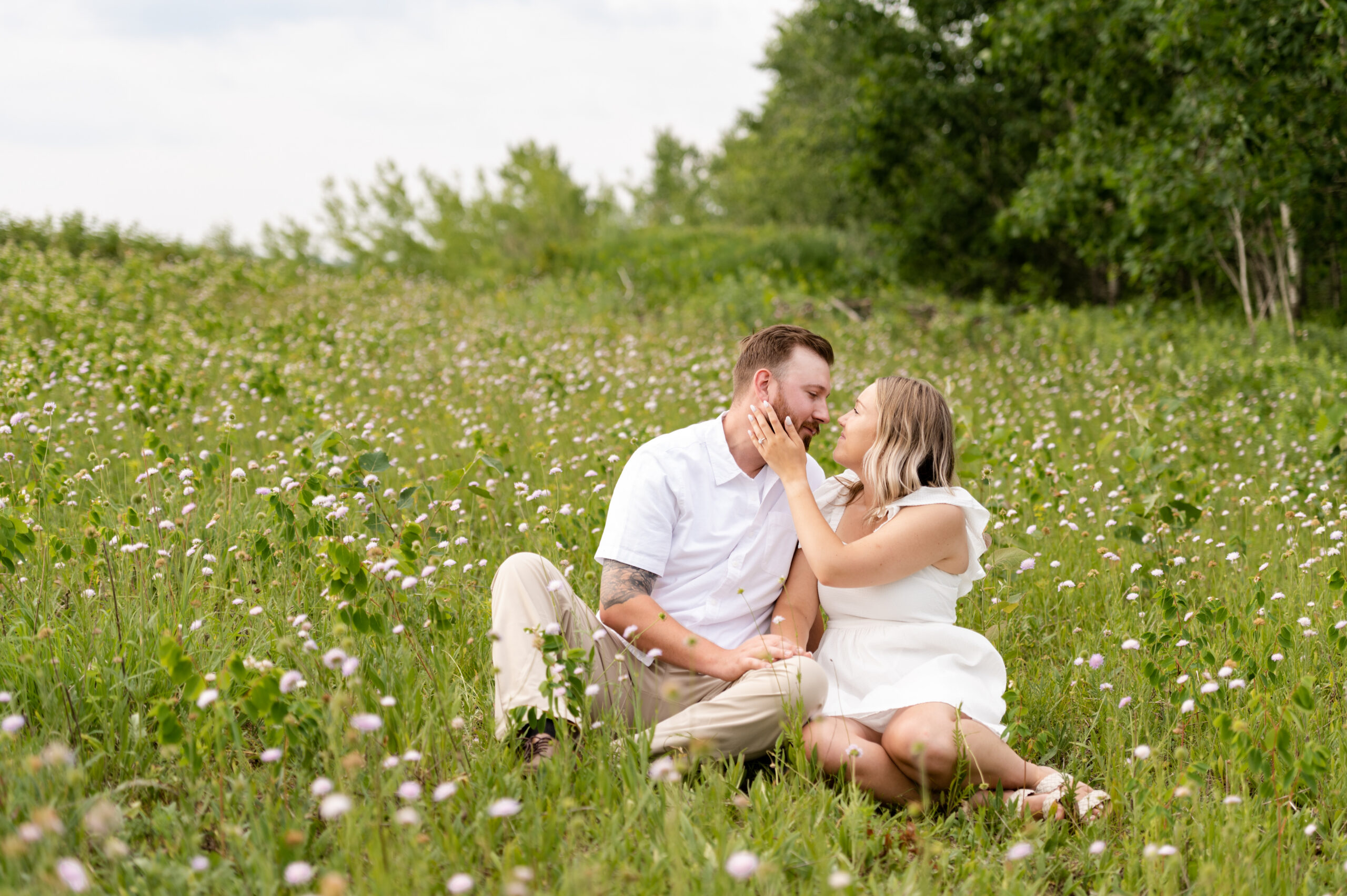 Couple sitting in a field of flowers